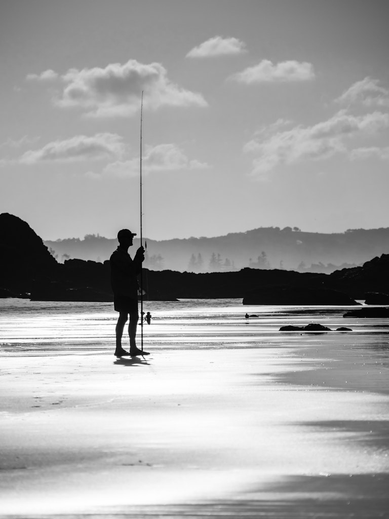 Byron Bay Fisherman - A fishermen ponders the conditions at Wategos Beach in Byron Bay.