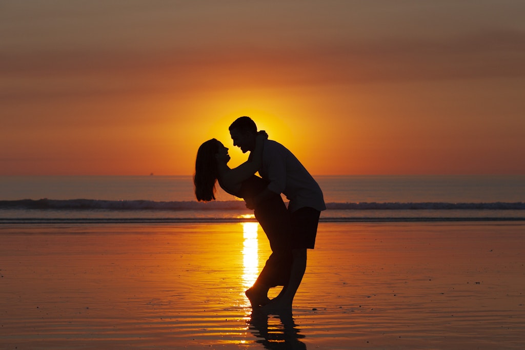 26 - silhouette of couple holding each other in front of Cable Beach sunset.